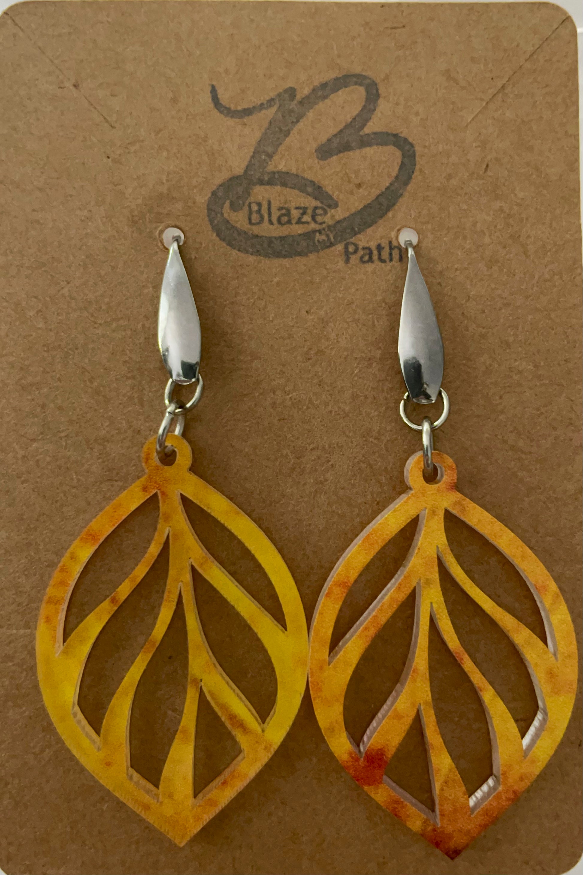 Golden yellow acrylic laser cut leaf pattern dangle earrings on stainless steel ear wires with teardrop feature