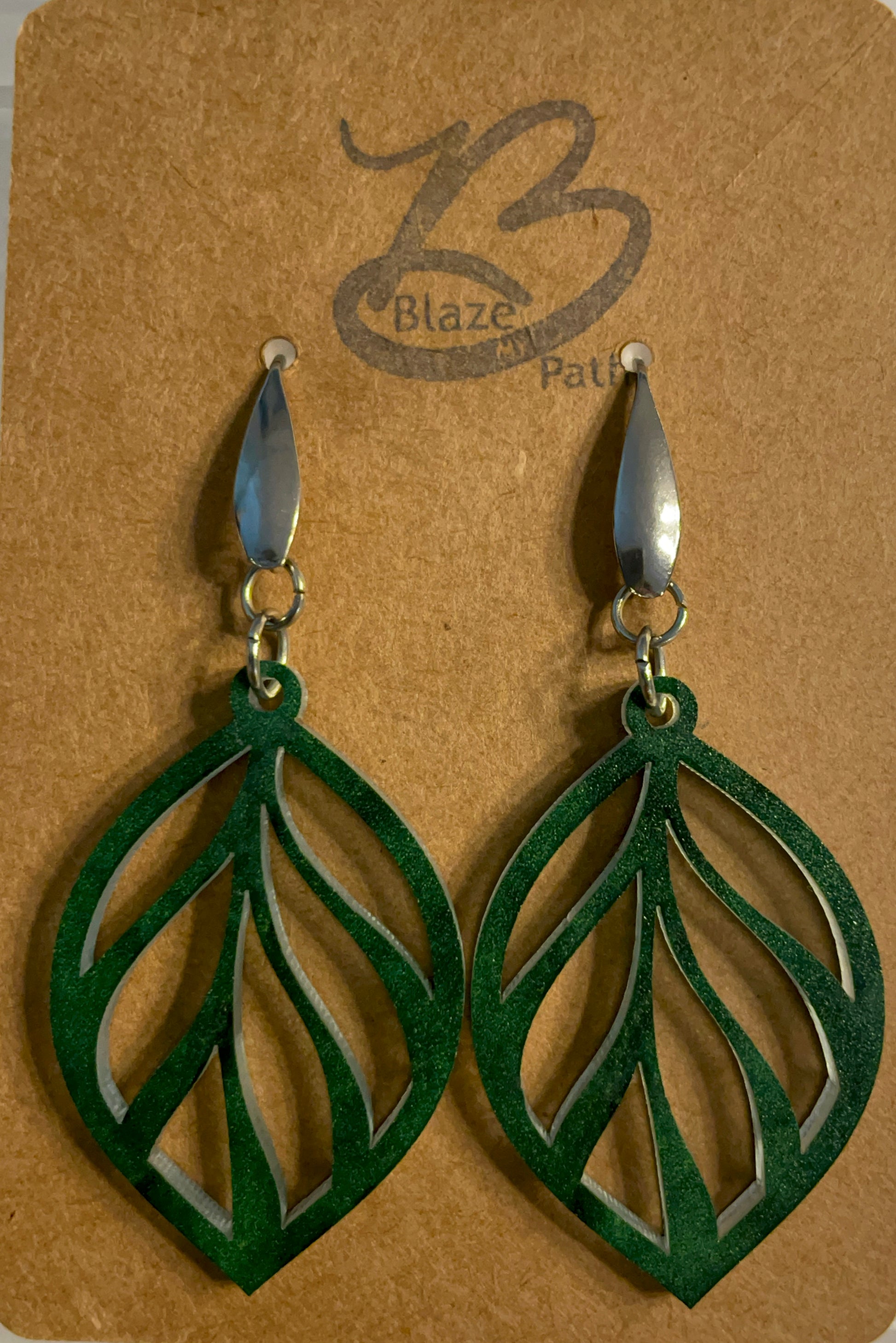 green acrylic laser cut leaf pattern dangle earrings on stainless steel ear wires with teardrop feature