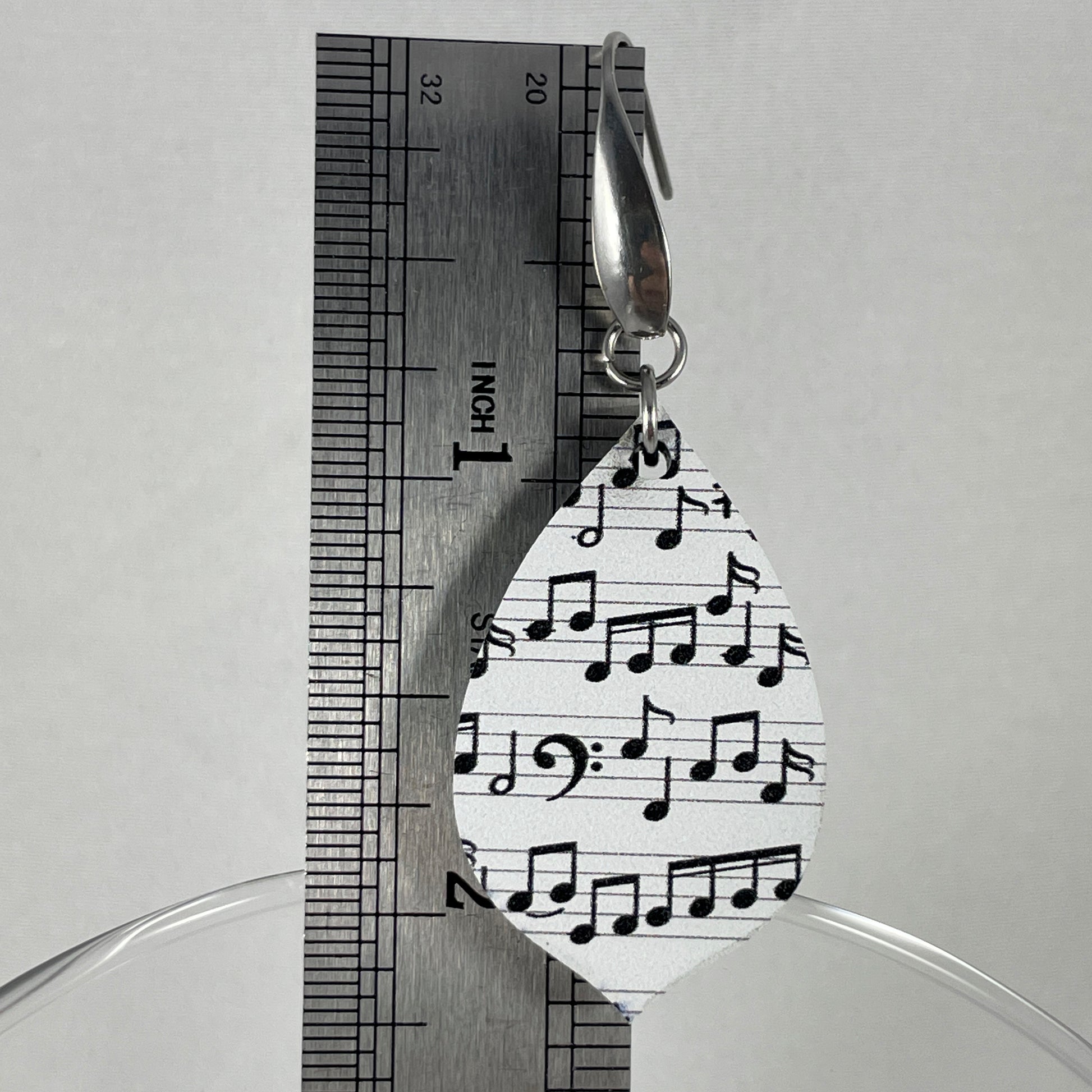 Size reference showing drop length of 2.25" of acrylic earrings with black music notes on white background and stainless steel ear wires with teardrop accent