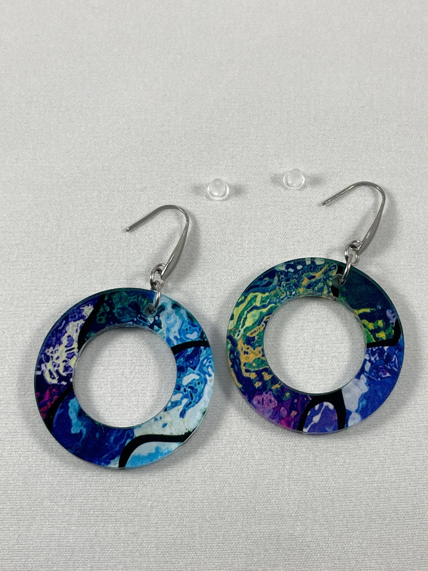 Detail view of Abstract multicolor chunky round acrylic dangle earrings on stainless steel ear wires with teardrop accent and included silicone earring backs