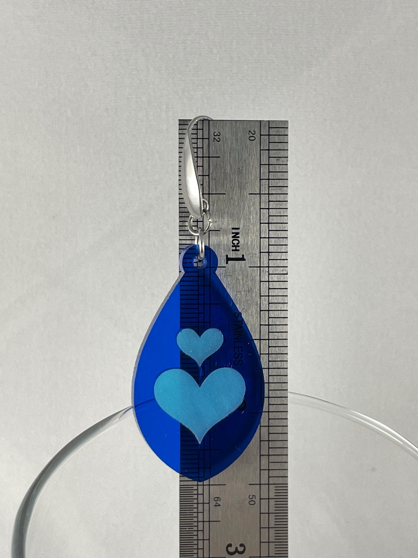 Size reference showing drop length of 2.5" for lapis blue acrylic teardrop earrings with light blue inlay hearts on stainless steel ear wires with teardrop accent