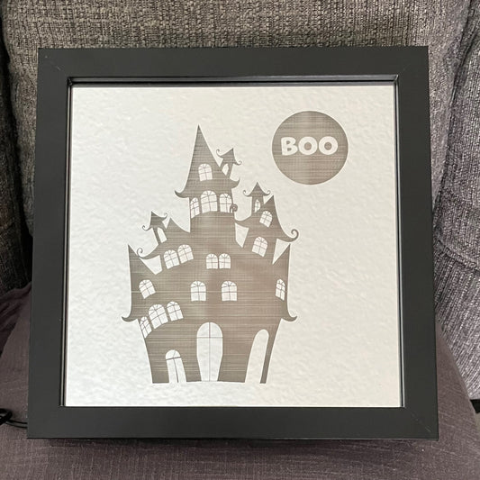 Haunted house engraved on mirror in black square shadow box frame