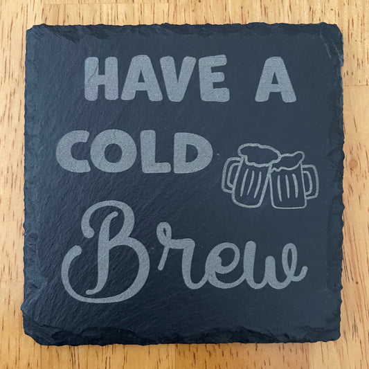 Square black slate coaster laser engraved with Have a Cold Brew